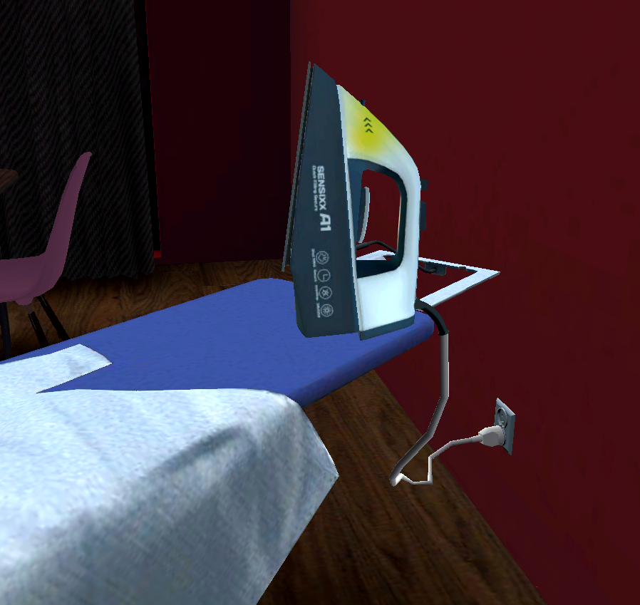 Podpięte do prądu żelasko, pozostawione bez nadzoru na desce do prasowania.